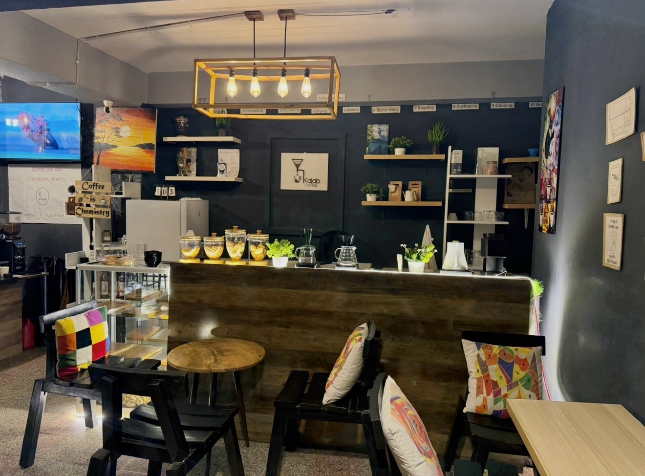 The espresso bar under the lightbulb chandelier