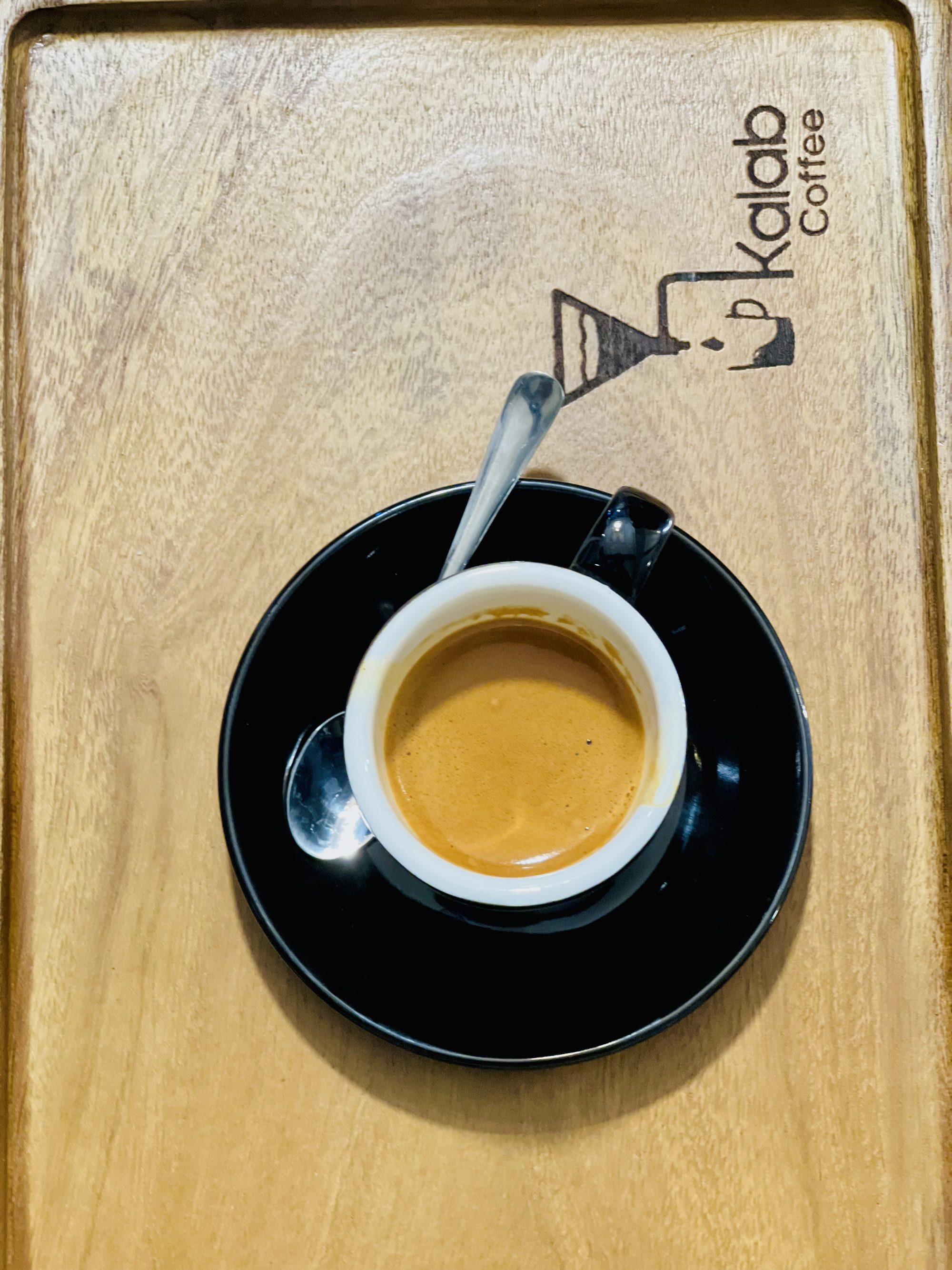 Kalab Coffee espresso on a branded wooden tray